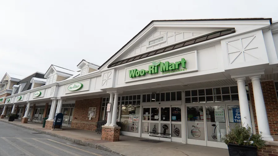 The Woo-Ri Mart storefront, with the green sign above the entrance